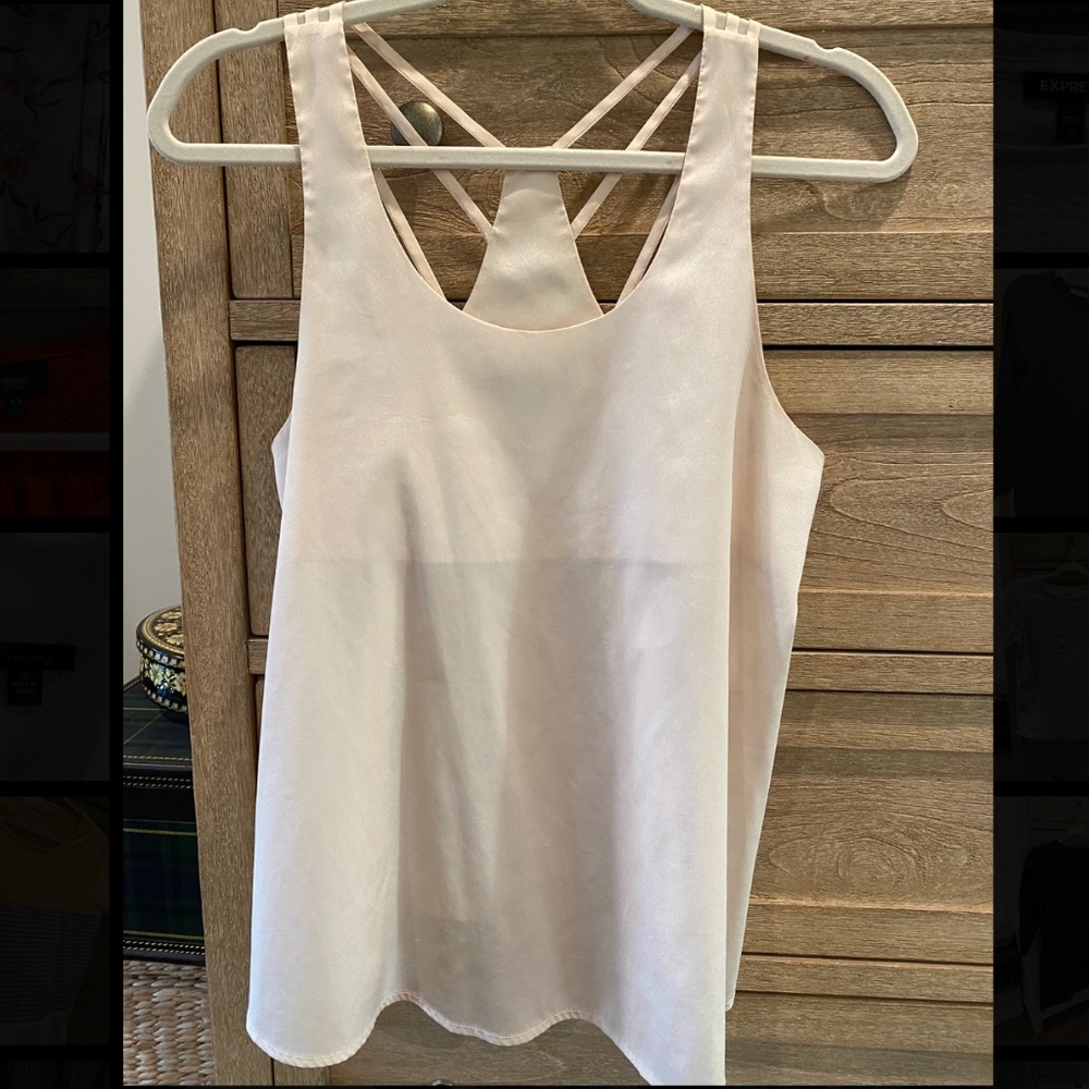 Light pink sleek sleeveless blouse with back detail